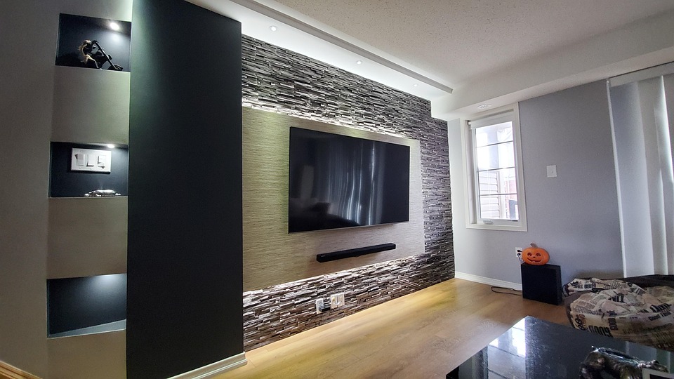 Finished basement lounge with sectional seating and built-in bar